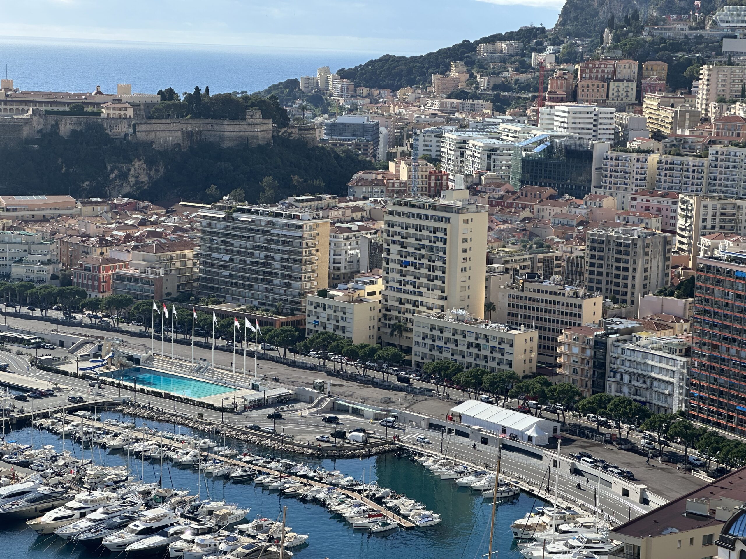 Aerial view of Porto Bello and La Condamine neighbourhood with Port Hercule marina and the Prince's Palace in the background, Monaco real estate