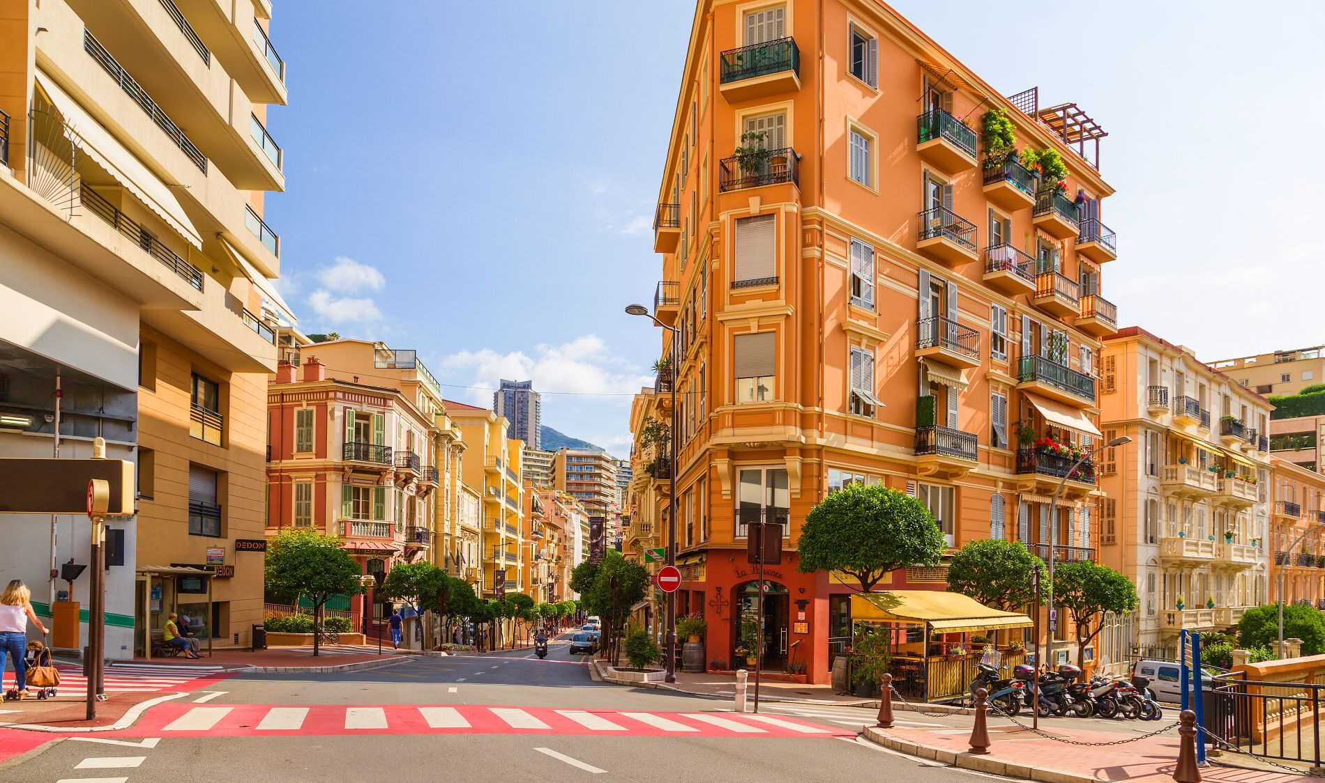 Corner buildings and café terraces on Rue Grimaldi in La Condamine Monaco