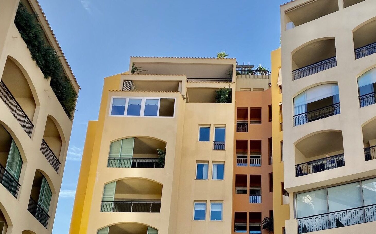 Michelangelo Building facade with colourful Mediterranean architecture and private balconies, luxury apartments for sale and rent in Monaco