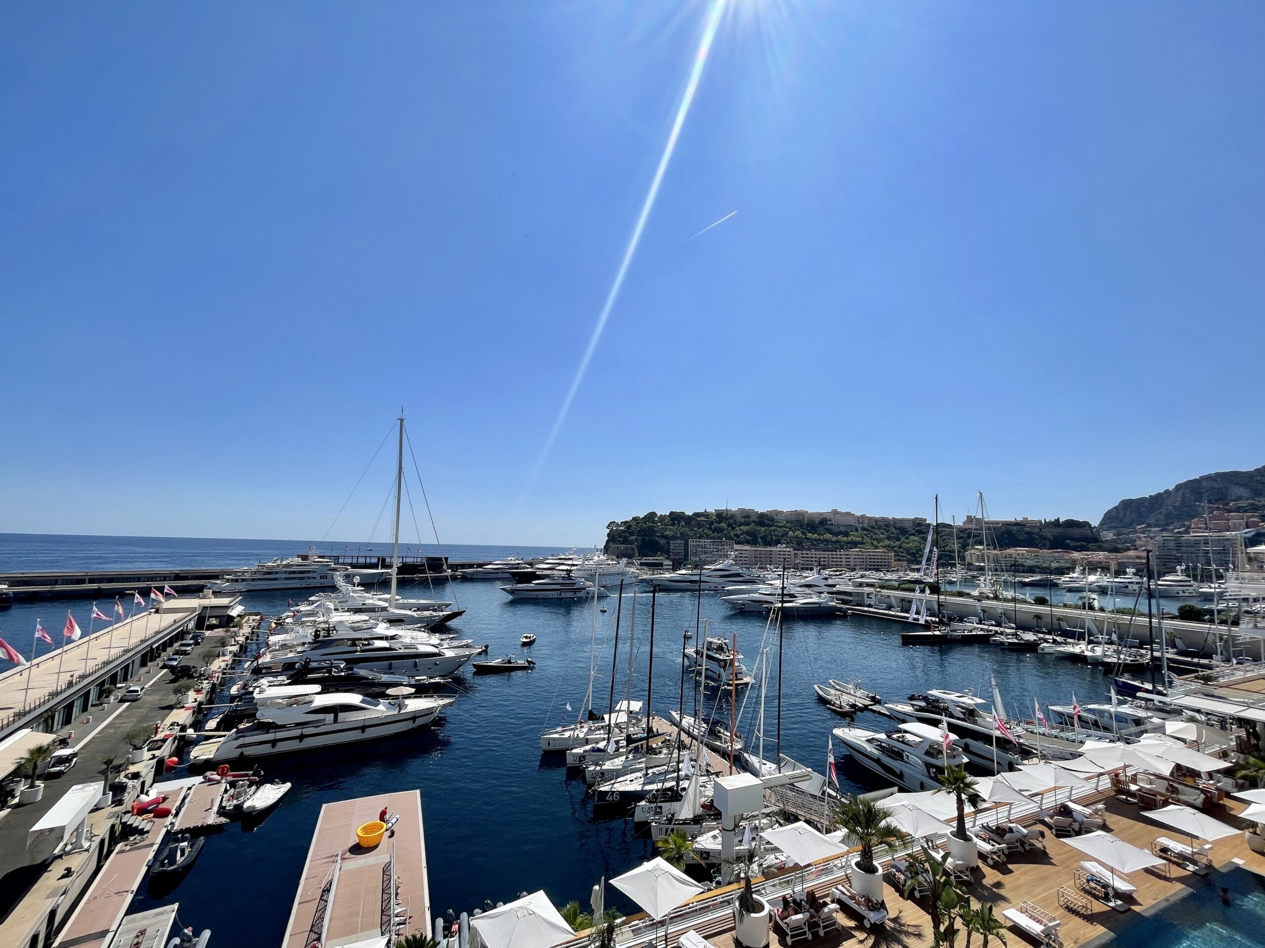 View from a Monte Carlo Star apartment overlooking Port Hercule with superyachts and the Prince's Palace on the rock, La Condamine Monaco
