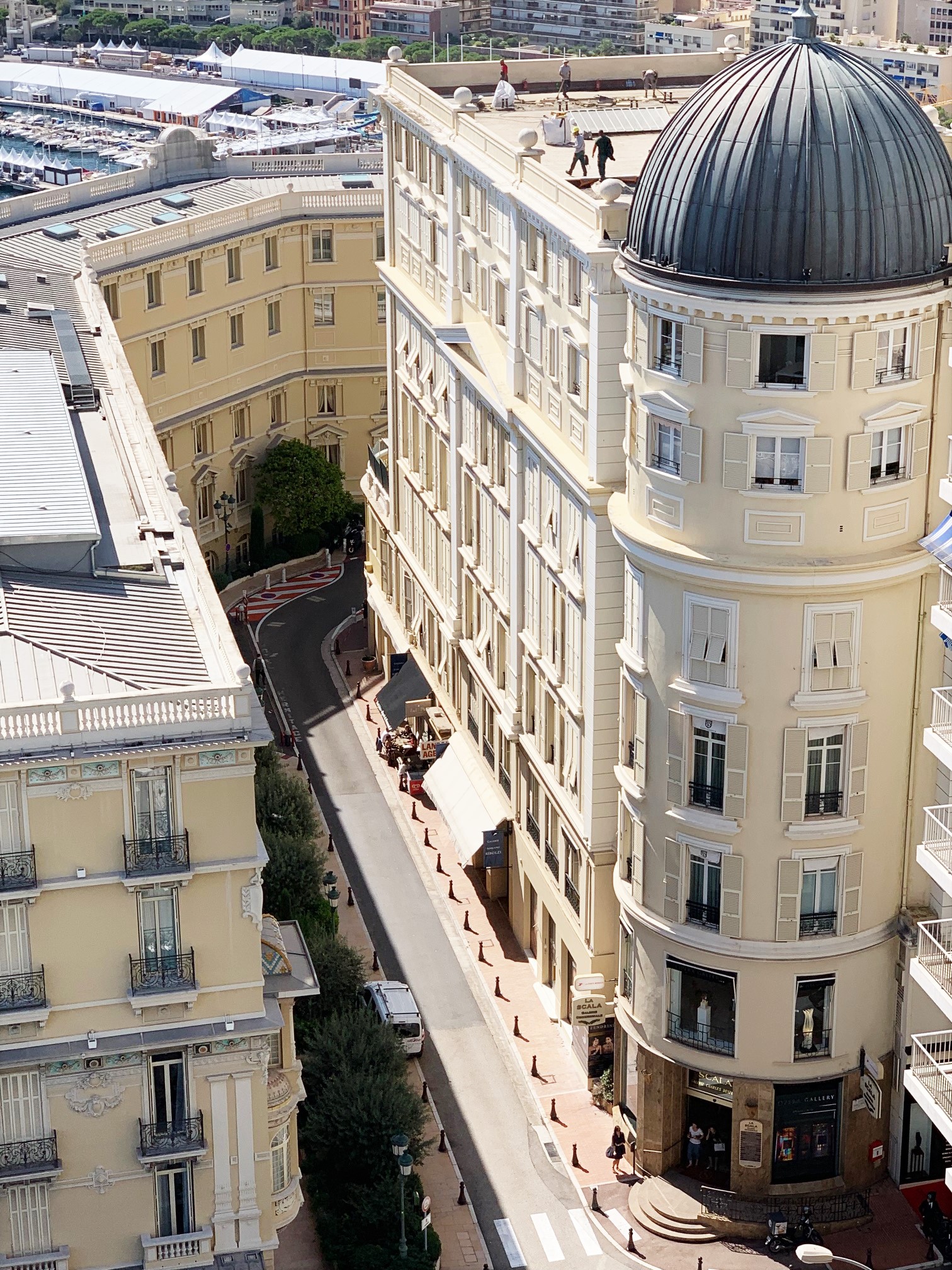 Palais de la Scala domed Belle Époque building in Monte-Carlo viewed from above, with Port Hercule and the Formula 1 circuit street in the background