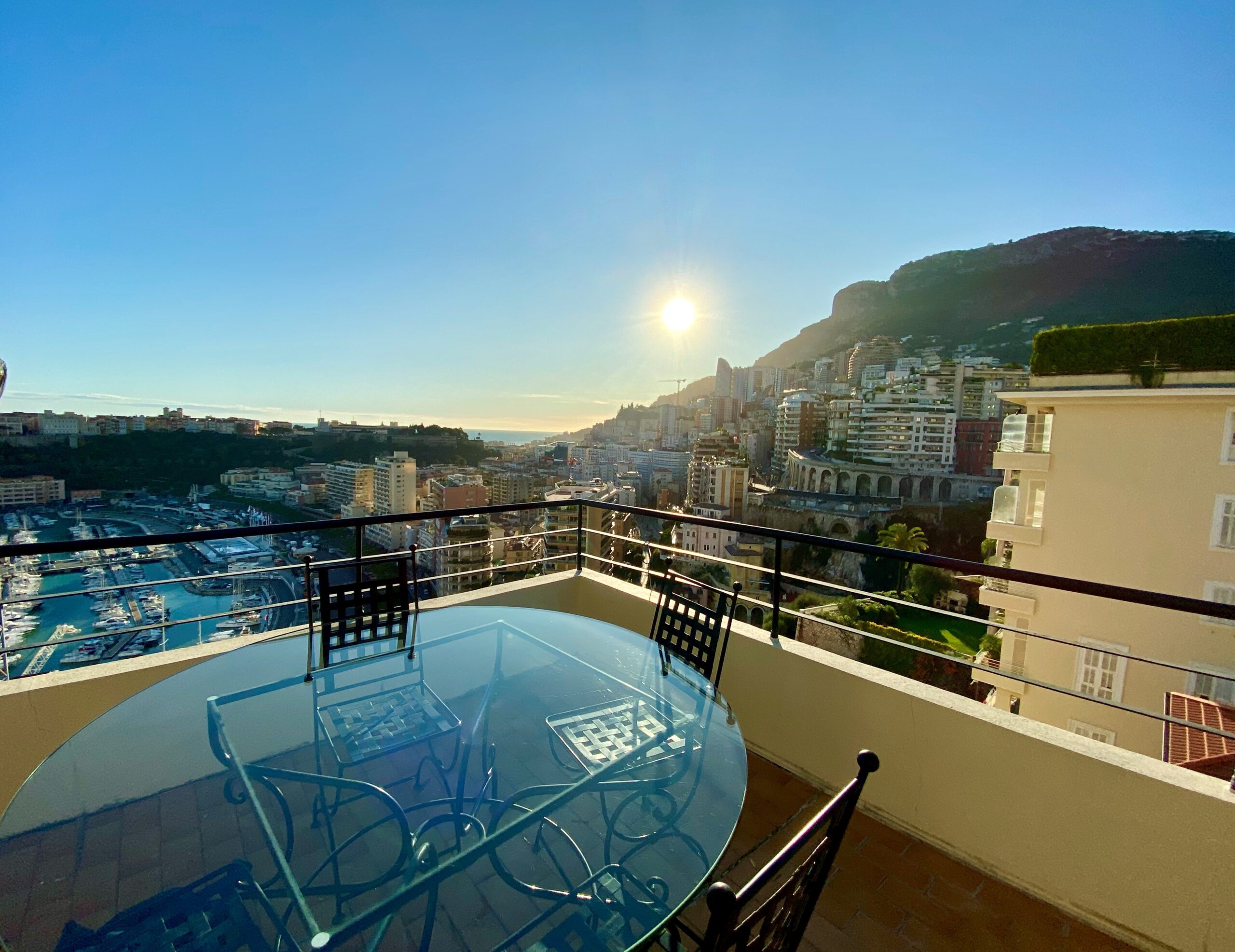 Rose de France luxury apartment terrace with panoramic views over Monaco harbour and cityscape at sunset, sought-after property for sale and rent in Monaco