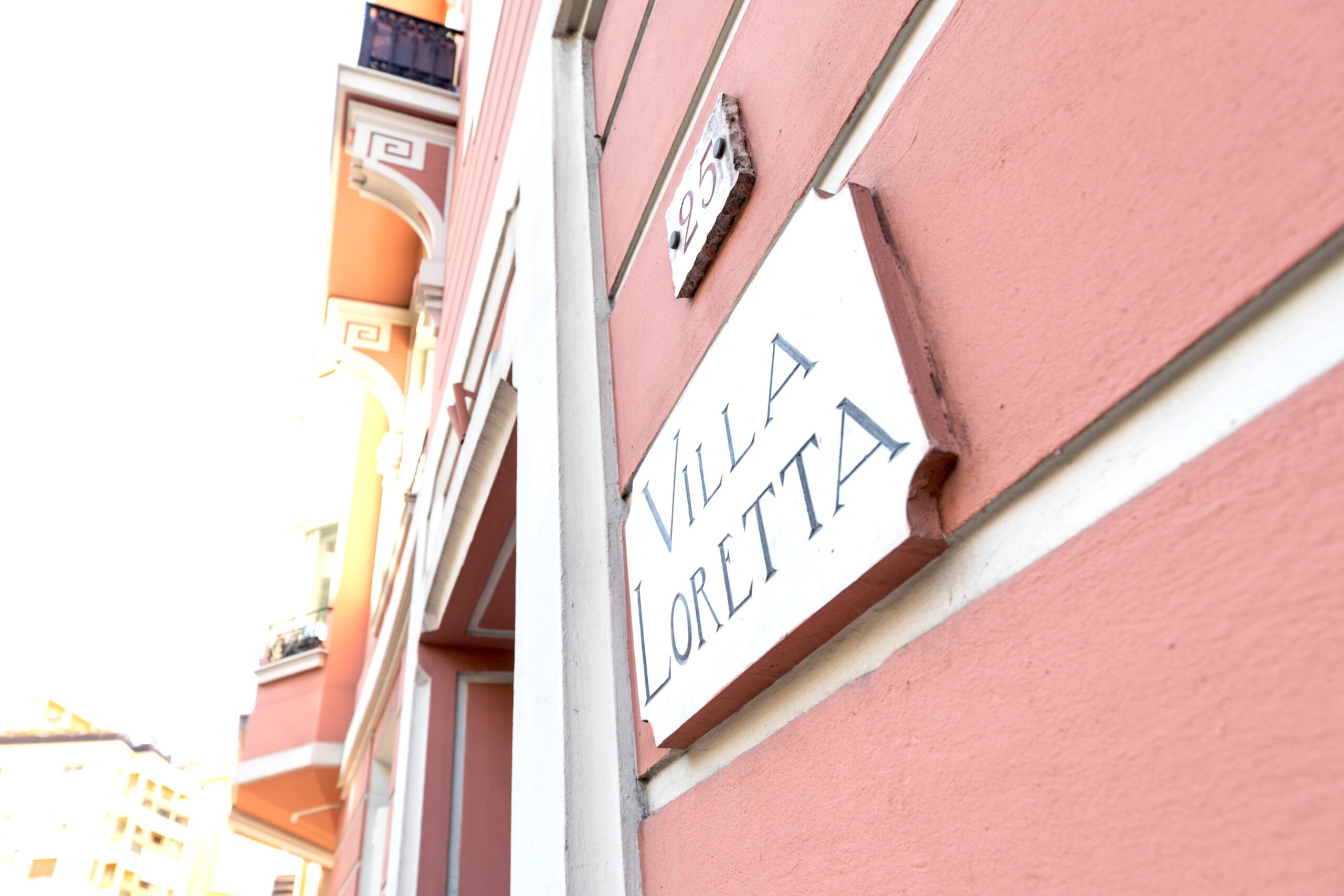 Villa Loretta name plaque on a pink Belle Époque facade in Monte-Carlo Monaco