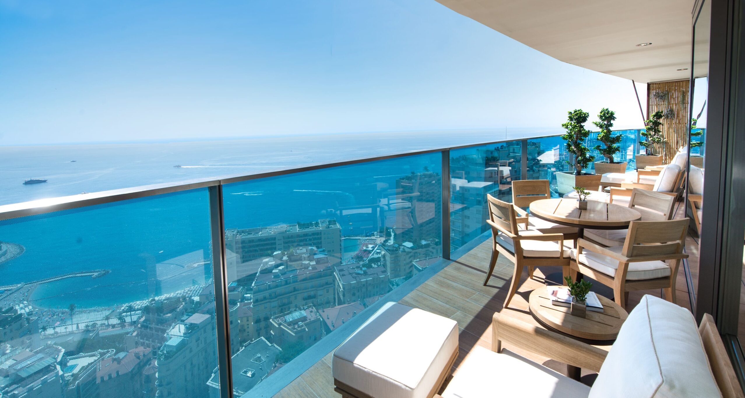 Tour Odéon luxury apartment balcony with panoramic Mediterranean Sea and Monaco cityscape views, high-rise property for sale in Monaco