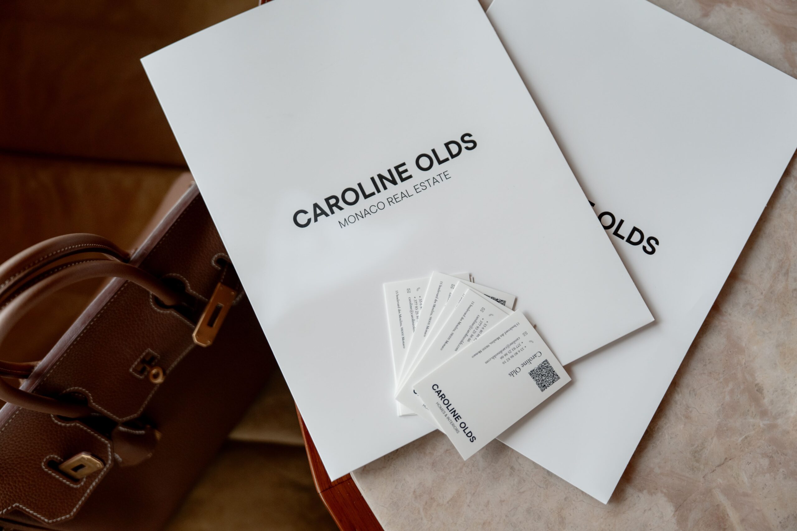 Caroline Olds Monaco Real Estate branded folders and business cards, luxury property agency branding for Monaco sales and rentals