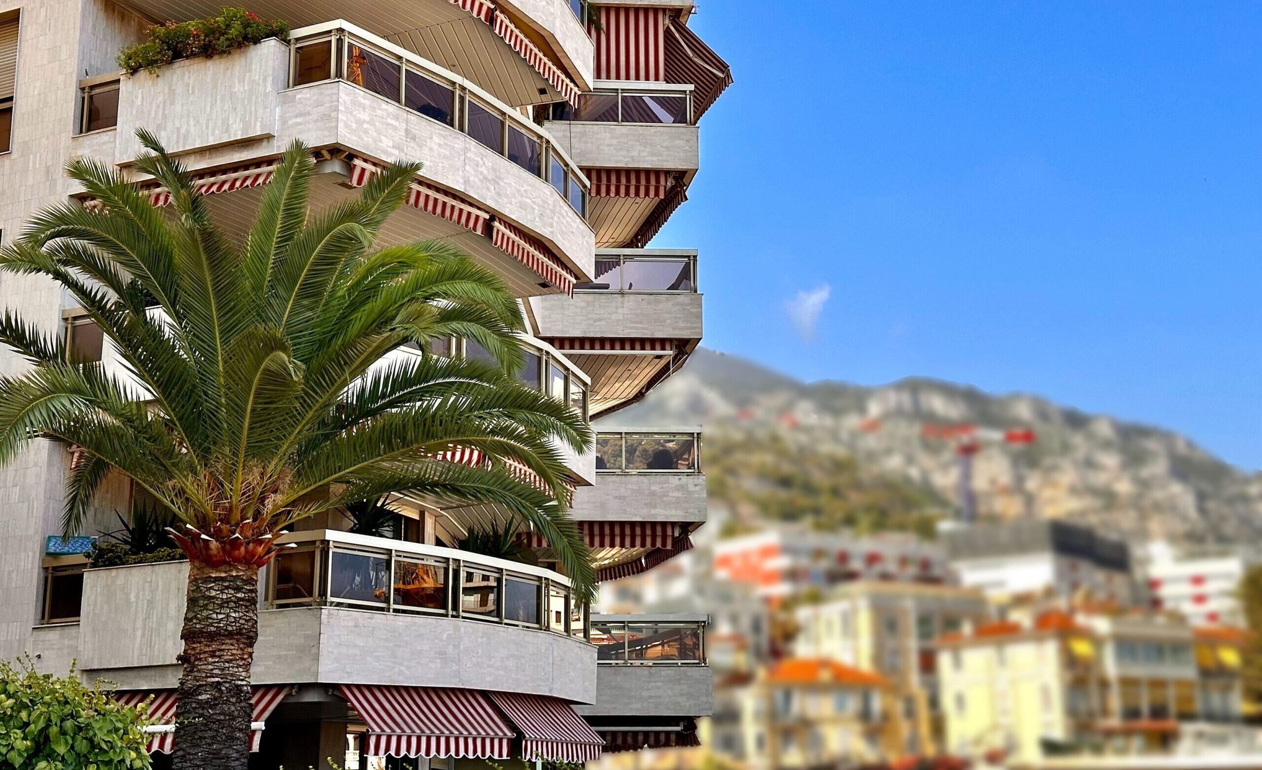 Harbour Lights residential building in Monaco with mountain backdrop