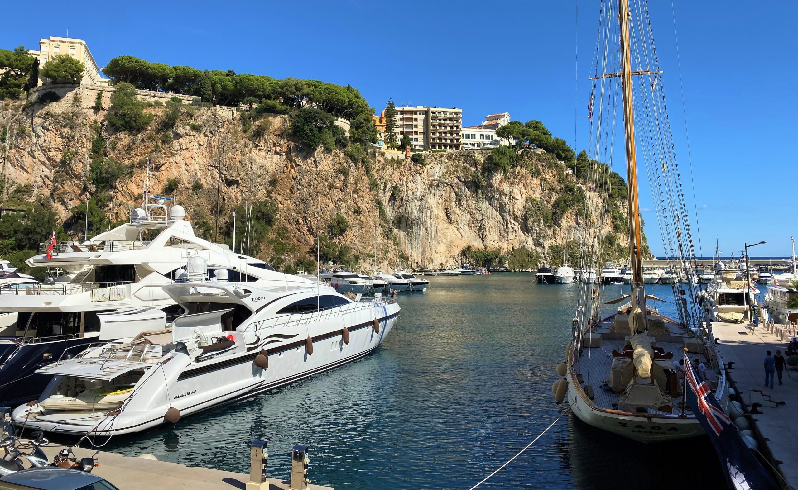 Fontvieille port view, white boat and Rocher in the background
