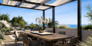 Outdoor dining terrace at Villa Annonciade Monaco under a pergola with sea view beyond