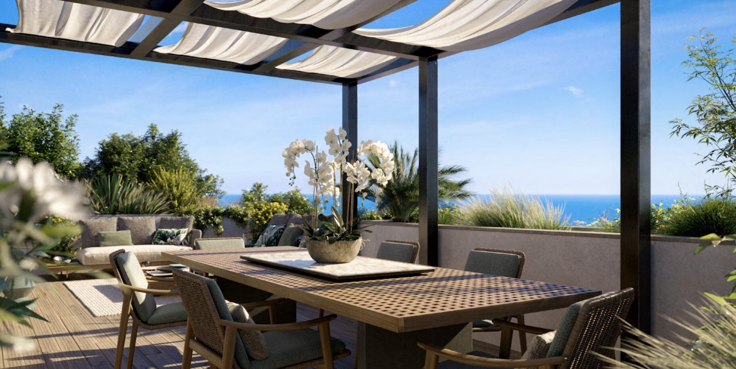 Outdoor dining terrace at Villa Annonciade Monaco under a pergola with sea view beyond