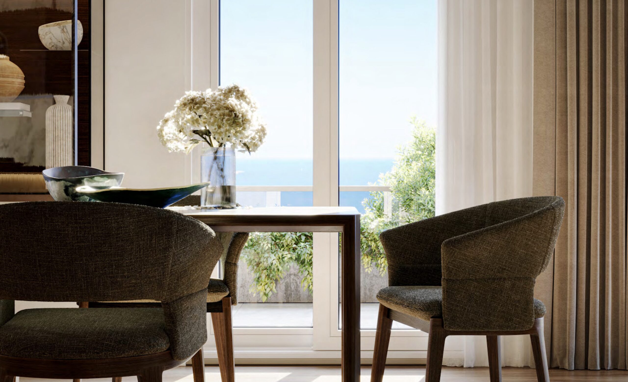 Dining table and chairs at Villa Annonciade Monaco with a floor to ceiling sea view window